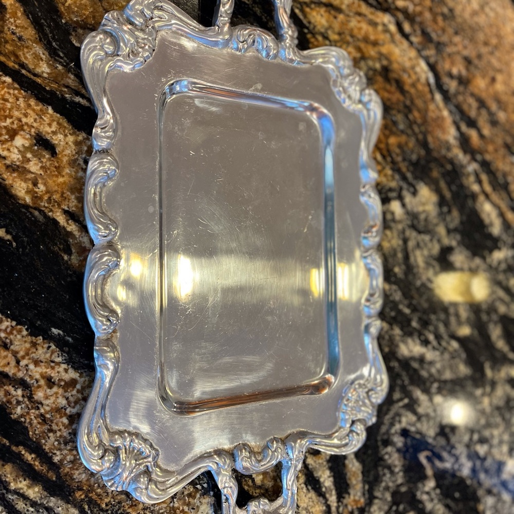 Pewter tray with decorative handles and edges